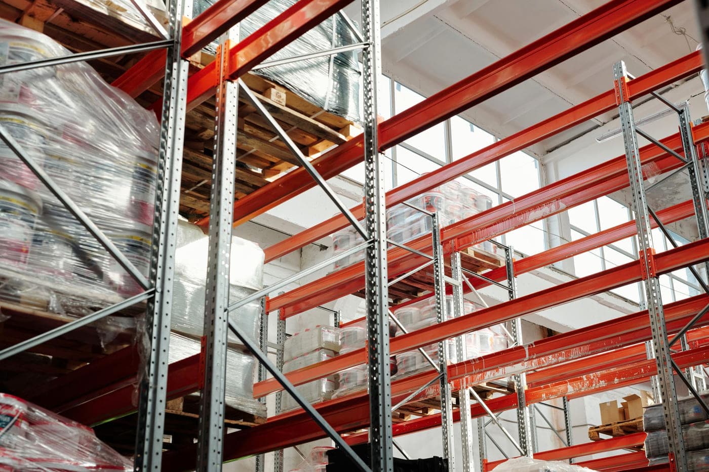 Interior of a warehouse with high racking and stored pallets